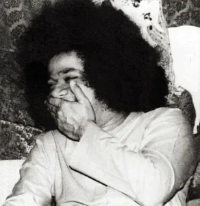 Sri Sathya Sai Baba laughing with divine joy