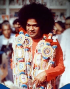 Bhagwan Shri Sathya Sai Baba wearing flower garlands