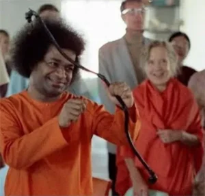 Bhagawan Sri Sathya Sai Baba demonstrating archery with devotees