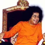Bhagawan Sri Sathya Sai Baba smiling on throne