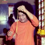 Bhagwan Shri Sathya Sai Baba holding sacred thread