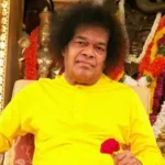 Bhagwan Shri Sathya Sai Baba holding red rose