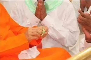 Sri Sathya Sai Baba presenting divine rings to devotee
