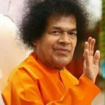 Sri Sathya Sai Baba blessing devotees with raised hand