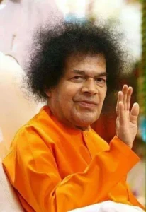Sri Sathya Sai Baba blessing devotees with raised hand