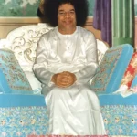 Bhagwan Shri Sathya Sai Baba seated smiling peacefully