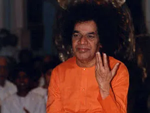 Sri Sathya Sai Baba blessing devotees with raised hand