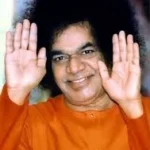Sri Sathya Sai Baba blessing devotees with raised hands