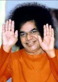 Sri Sathya Sai Baba blessing devotees with raised hands