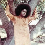 Sri Sathya Sai Baba standing beneath sacred tree