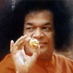Sri Sathya Sai Baba holding divine golden ring