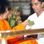 Sathya Sai Baba giving a blessing item.