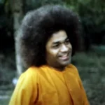 Bhagawan Sri Sathya Sai Baba smiling gracefully outdoors