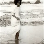 Young Sri Sathya Sai Baba walking through sacred river