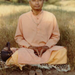 Sathya Sai devotee seated in meditation outdoors with peaceful expression