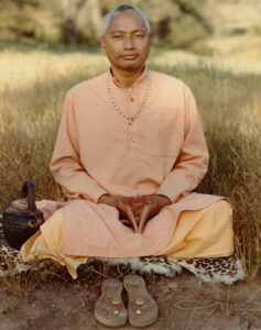 Sathya Sai devotee seated in meditation outdoors with peaceful expression