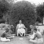 Swami Sivananda teaching disciples during outdoor spiritual study session