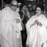 Swami Sivananda greeting devotee during spiritual gathering