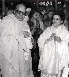 Swami Sivananda greeting devotee during spiritual gathering