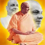 Swami Sivananda sitting in orange robes.