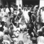 Swami Sivananda blessing gathered devotees during sacred spiritual assembly with compassion