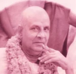 Swami Sivananda wearing flower garland gazing thoughtfully with serene expression always