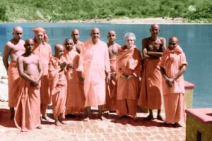 Swami Sivananda with disciples beside river discussing spiritual psychology together