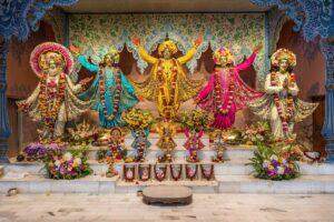 Pancha Tattva deities adorned with colorful flower garlands
