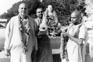 Swami Sivananda with disciples carrying sacred idol