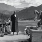 Yoga practitioner demonstrating advanced pose before guru and attentive disciples together