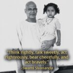 Swami Sivananda holding a little girl.