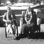Swami Venkateshananda and Swami Sivananda sitting outdoors.