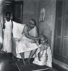 Sri Aurobindo blessing young devotee lovingly