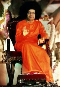 Shri Sathya Sai Baba blessing seated devotees