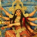 Goddess Durga with ten arms holding divine weapons and blessing devotees