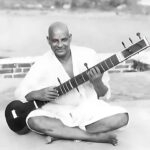Swami Sivananda playing veena with joyful devotion