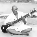Swami Sivananda playing veena with joyful devotion