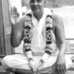 Swami Sivananda blessing devotees with raised hand