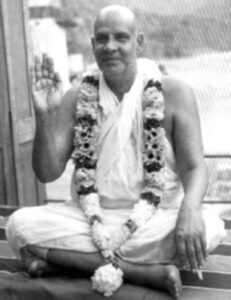 Swami Sivananda blessing devotees with raised hand