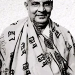 Swami Sivananda smiling wearing sacred spiritual shawl