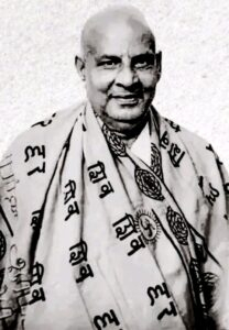 Swami Sivananda smiling wearing sacred spiritual shawl