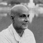 Swami Sivananda gazing peacefully beside sacred river