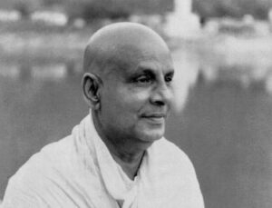 Swami Sivananda gazing peacefully beside sacred river