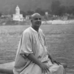 Swami Sivananda seated beside Ganga river image