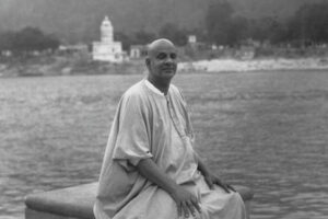 Swami Sivananda seated beside Ganga river image