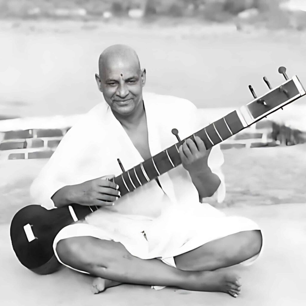 Swami Sivananda playing veena with peaceful spiritual joy