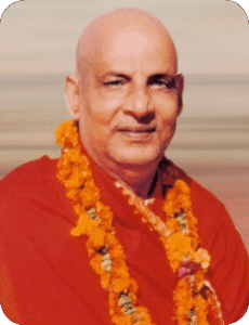 Swami Sivananda wearing flower garlands smiling peacefully