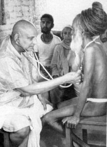 Swami Sivananda compassionately serving spiritual seekers selflessly