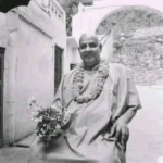 Divine Life Society Rishikesh guru wearing flower garland seated peacefully