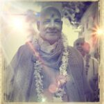 Swami Sivananda wearing flower garland with peaceful smile